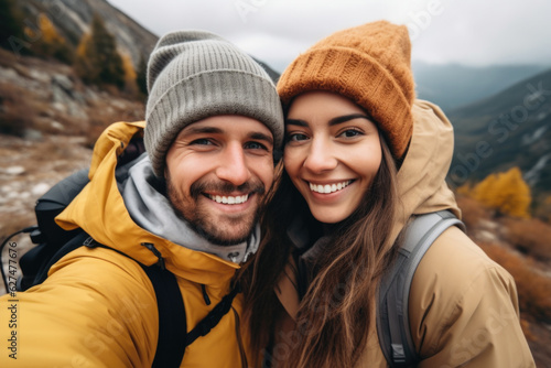 Selfie photo of happy smiling young couple during traveling together at beautiful destination in the mountains