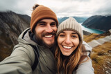Selfie photo of happy smiling young couple during traveling together at beautiful destination in the mountains
