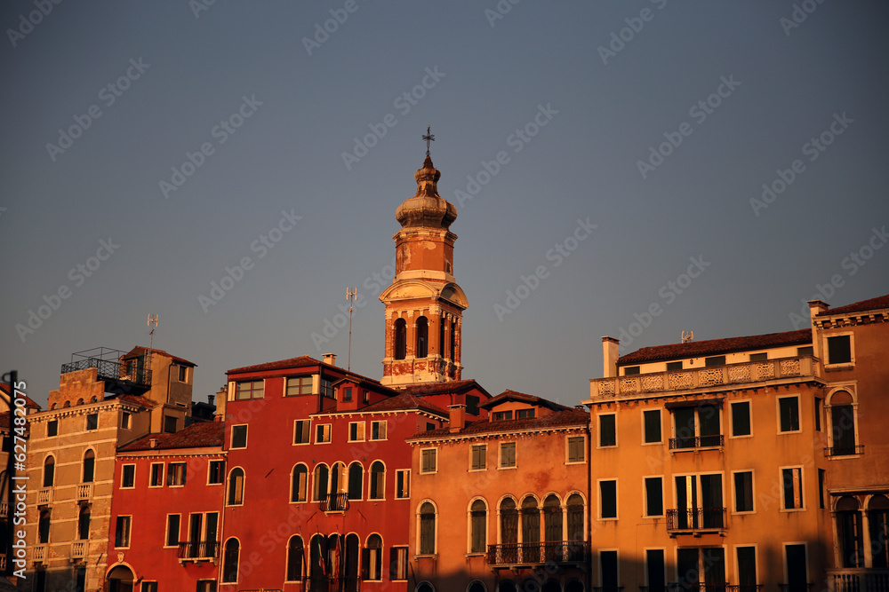 Old and aged historical buildings near the channel in Venice Italy during sunset