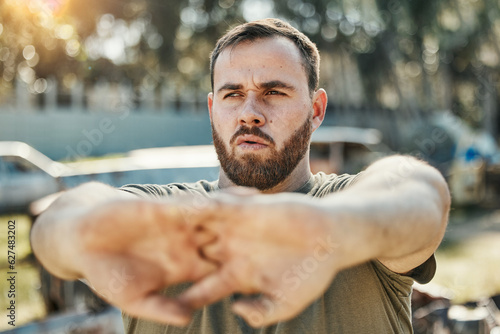 Focus, stretching and a man in nature for fitness, running idea and thinking of motivation for a workout. Serious, hands and an athlete with a vision for training, exercise or a warm up in a park