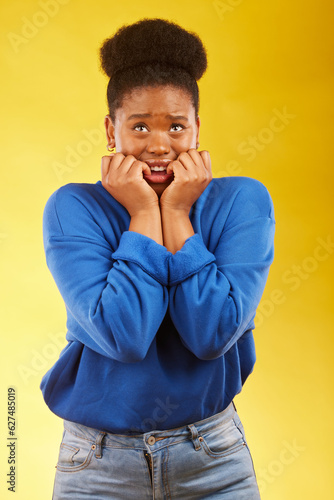 Fotografi Anxiety, fear and black woman biting nails in studio with terror, guilt and shocking drama on yellow background