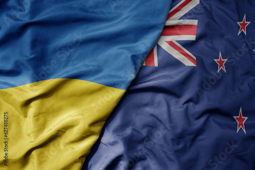 big waving national colorful flag of ukraine and national flag of new zealand . © luzitanija