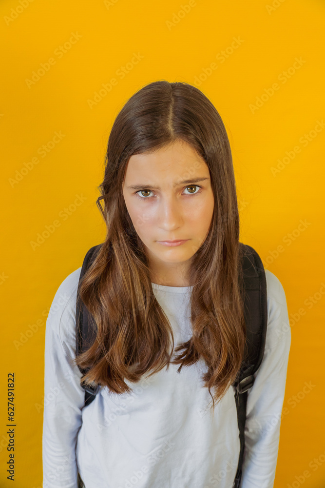 Little sad girl schoolgirl with backpack is sad because of school Little sad girl schoolgirl with backpack is sad because of school