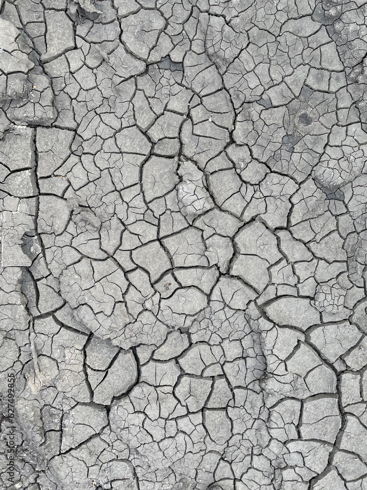 Cracked black dry dirt texture. Natural background Cracked black dry dirt texture. Natural background