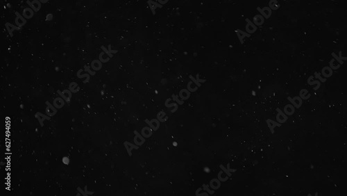 Floating Dust Particles In The Air Against A Dark Background. Tiny Specks Of Light Reflect Off The Fine Particles, Creating A Mysterious And Atmospheric Scene.