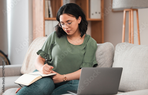 Woman, student and laptop, writing in notebook and planning schedule, work from home or online education on sofa. Person with journal ideas or studying in college or university e learning on computer