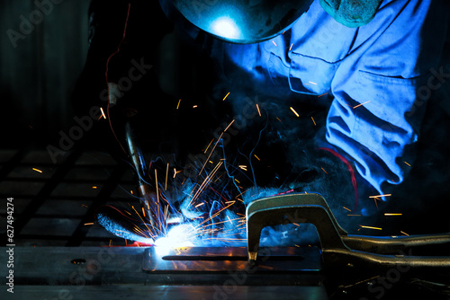 Professional welder carries out welding works with semi automatic argon arc welding works