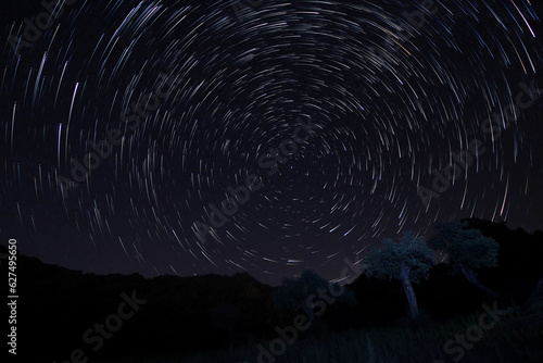 A view of the stars of the Milky Way with a mountain top in the foreground. Night sky nature summer landscape. Perseid Meteor Shower observation