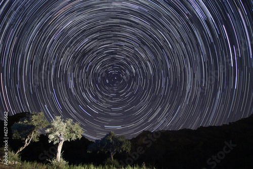 A view of the stars of the Milky Way with a mountain top in the foreground. Night sky nature summer landscape. Perseid Meteor Shower observation