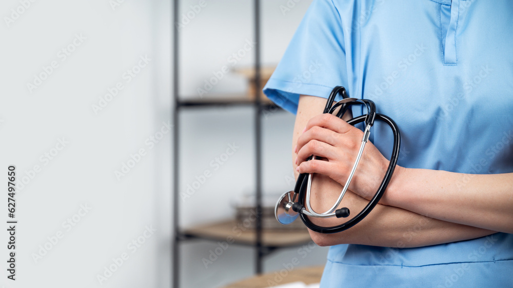 female doctor with crossed hands hold stethoscope female doctor with crossed hands hold stethoscope