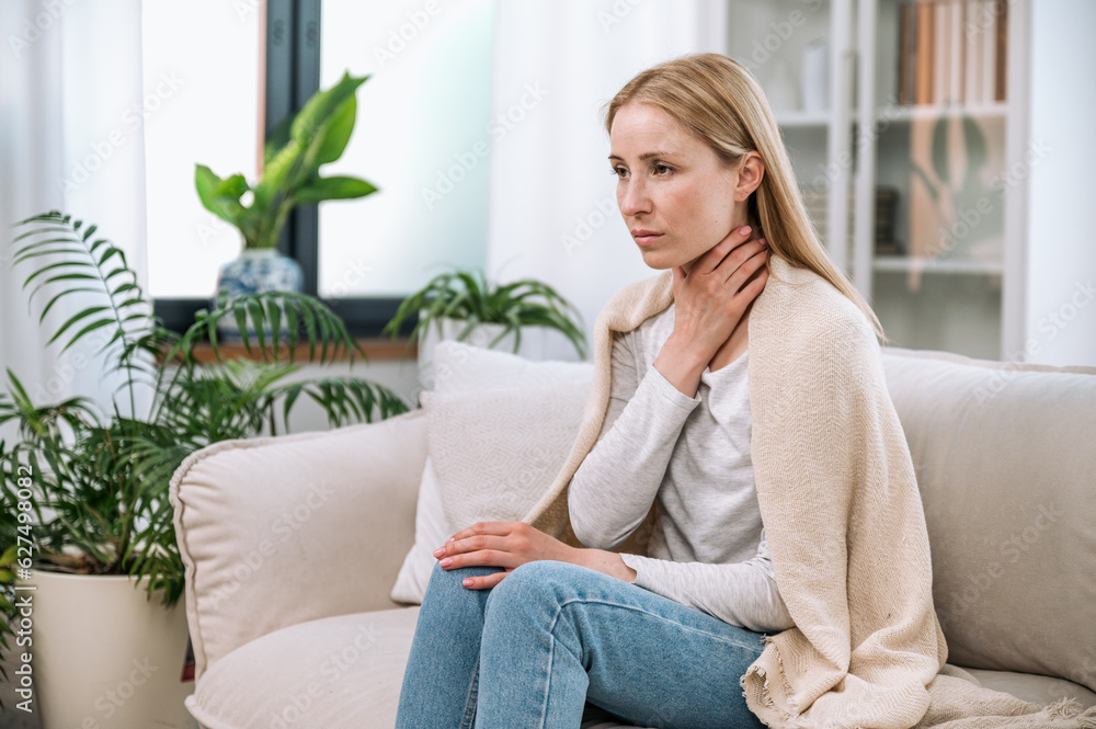 Sick upset woman touching neck and having painful sensations Sick upset woman touching neck and having painful sensations
