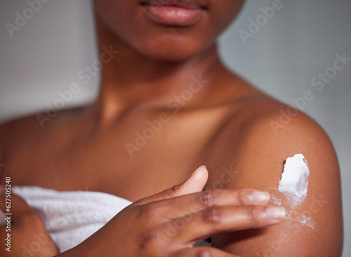 Body care, skin and closeup of woman with lotion for moisturizing, health and wellness. Cosmetics, creme and zoom of a female person with spf, sunscreen or moisturizer after a shower in the bathroom.