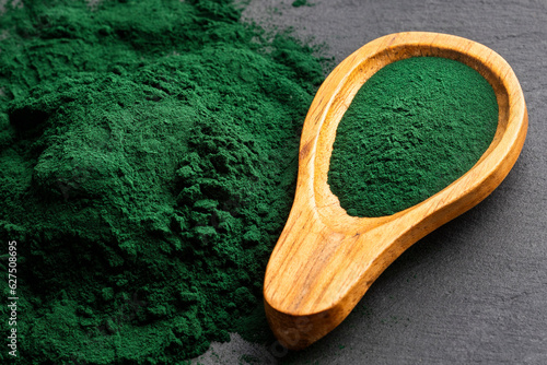 Spirulina powder healthy dietary supplement - Algae powder in spoon photo