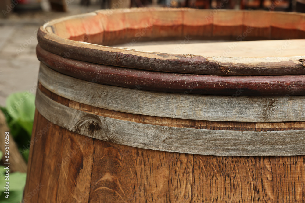 Fototapeta premium Traditional wooden barrel on street outdoors, closeup. Wine making
