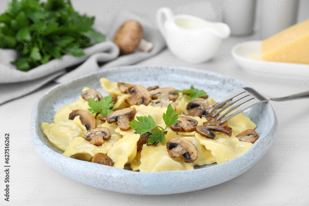 Delicious ravioli with mushrooms served on white table, closeup Delicious ravioli with mushrooms served on white table, closeup
