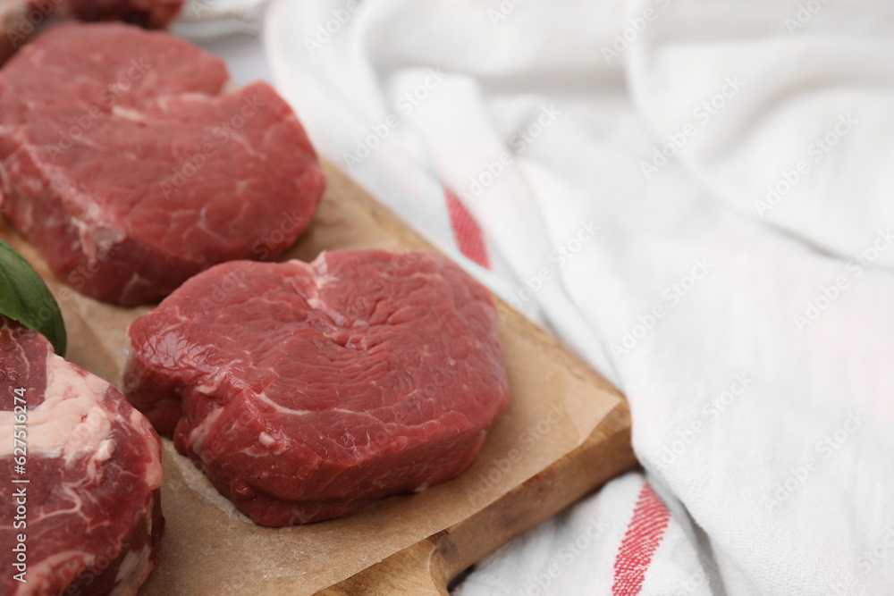 Cut fresh beef meat on wooden board, closeup. Space for text Cut fresh beef meat on wooden board, closeup. Space for text