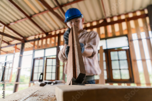Carpenter working on his desk in construction design Wearing a helmet and wearing goggles Selective focus