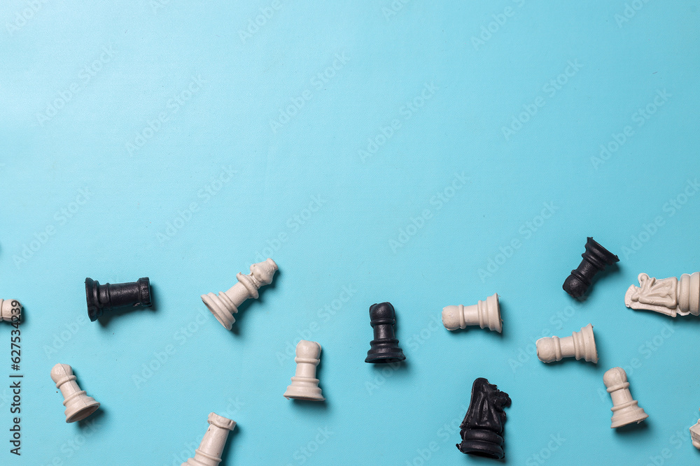 Fototapeta premium Top view of chess figures on blue background with free copy space for your text. Business strategy, decision and teamwork concept