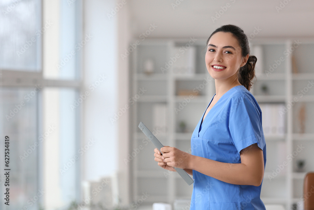 Female medical assistant with clipboard in clinic Female medical assistant with clipboard in clinic