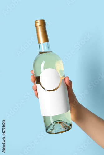 Female hand holding bottle ...