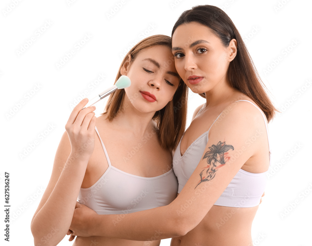 Young women with makeup brush on white background Young women with makeup brush on white background