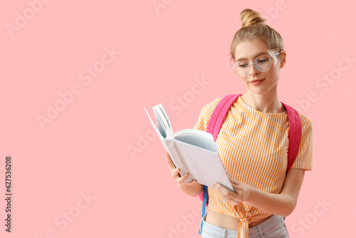 Female student reading book...