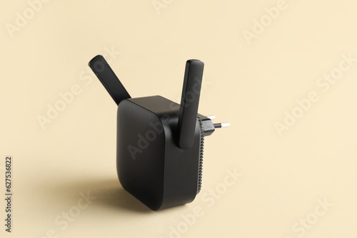 Принти на полотні Black WiFi repeater on beige background