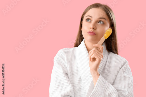 Thoughtful young woman hold...