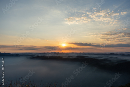 View of the sunset in the mountains with a lot of fog