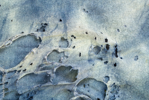 torn and faded shabby clothing material background