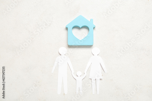 Figures of family with hous...