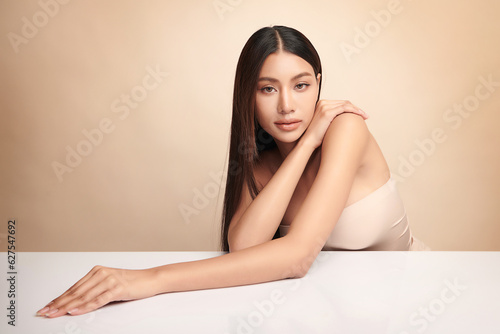 Beautiful young asian woman with clean fresh skin on beige background, Face care, Facial treatment, Cosmetology, beauty and spa, Asian women portrait.