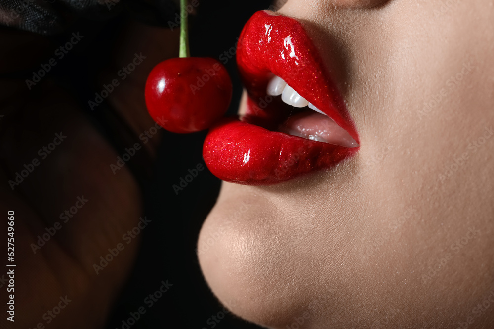 Beautiful woman with red lips and cherry on dark background, closeup - obrazy, fototapety, plakaty 