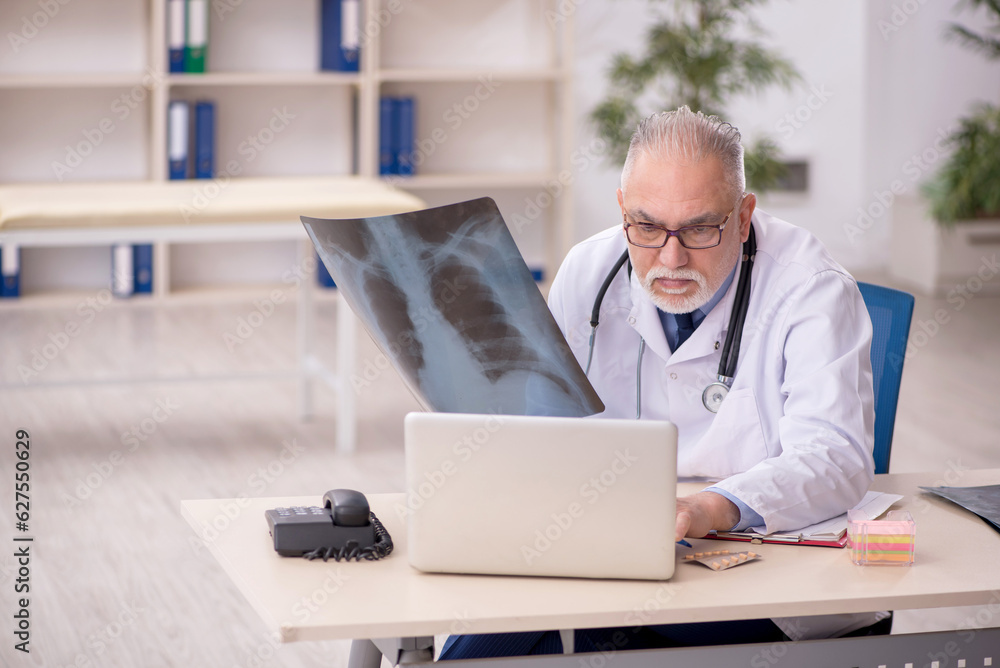 Old male doctor radiologist working in the clinic Old male doctor radiologist working in the clinic