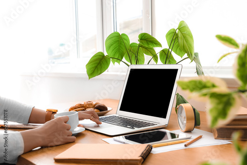 Woman working at table with...