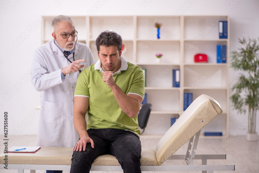 Fototapeta premium Young male patient visiting old male doctor