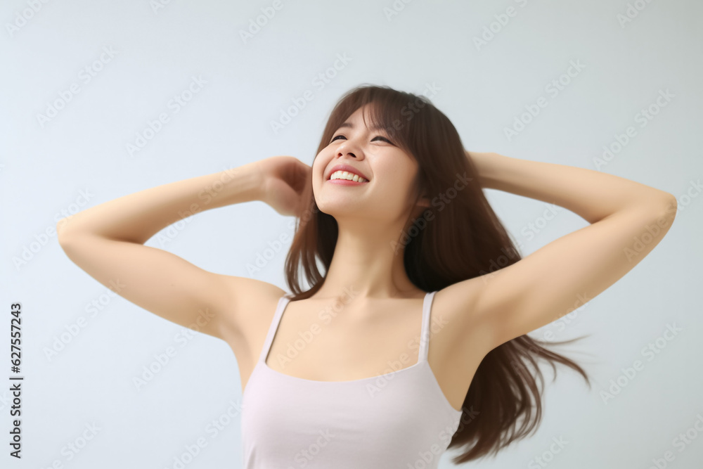 A young and pretty woman in a white underwear dress exudes joy and relaxation, raising her arms wide with a cute smile, revealing her smooth armpits against a pristine white background. Generative AI.