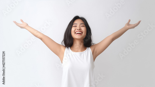 A young and pretty woman in a white underwear dress exudes joy and relaxation  raising her arms wide with a cute smile  revealing her smooth armpits against a pristine white background. Generative AI.