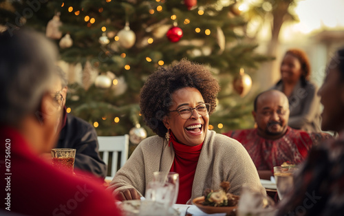 Smiling senior black african american dark-skinned woman celebrating christmas with her family at the holiday table 