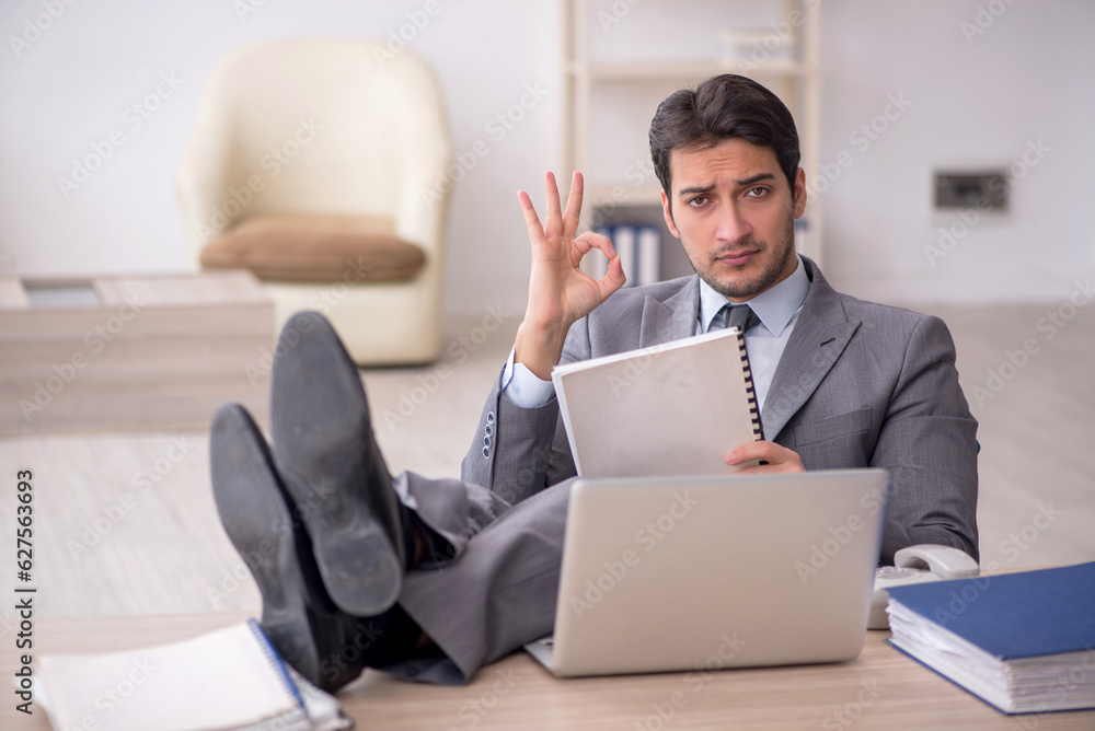 Young male employee working in the office Young male employee working in the office