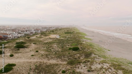 Sunset on the beach over sea overlooking vacation homes photo