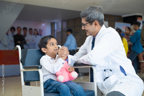 Doctor support and helping to child patient at hospital