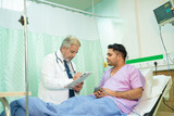 Doctor discussing with patient and note down prescription while medical examination.