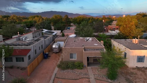 Adobe style home in beautiful housing development in southwest USA. Aerial rising shot at dusk with mountain background. photo