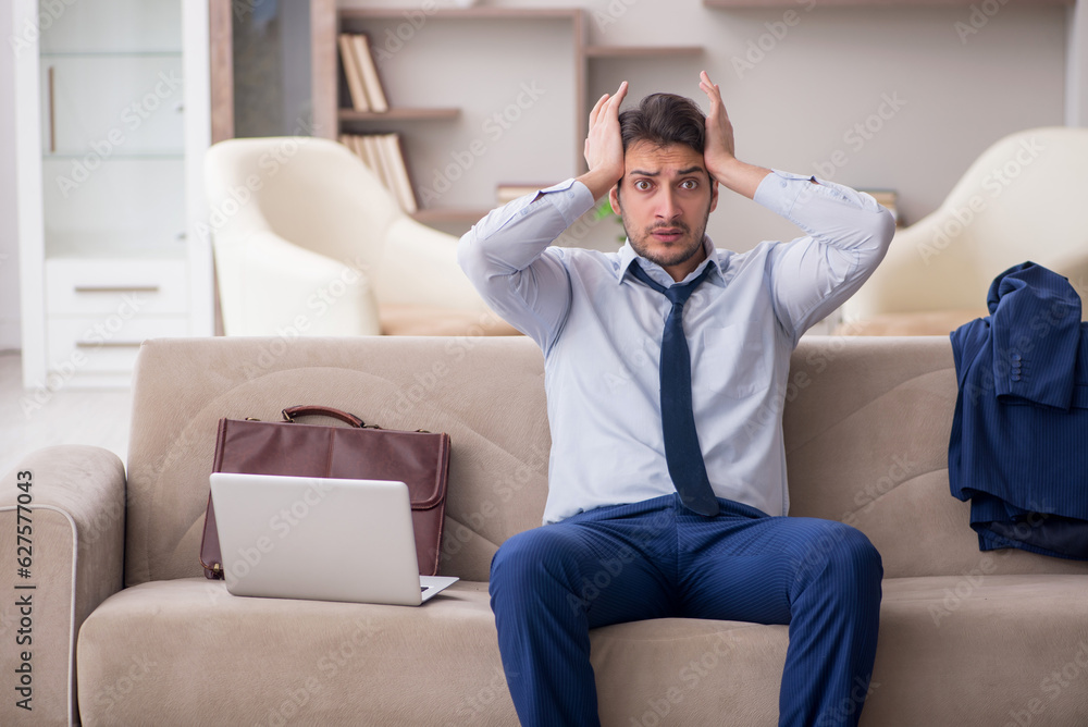 Young male employee working from home during pandemic Young male employee working from home during pandemic