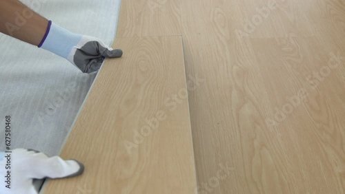 flooring installation and renovation. spc (Stone Plastic Composite) wooden texture surface. interior wooden flooring material