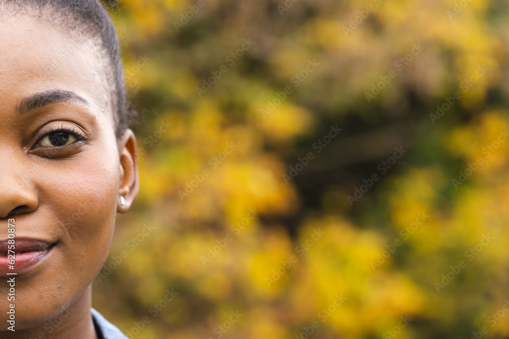 Half portrait of happy african american woman in garden smiling, copy space Half portrait of happy african american woman in garden smiling, copy space