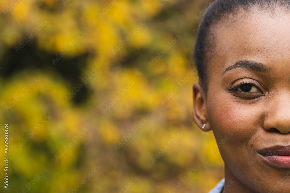 Half portrait of happy african american woman in garden smiling, copy space Half portrait of happy african american woman in garden smiling, copy space
