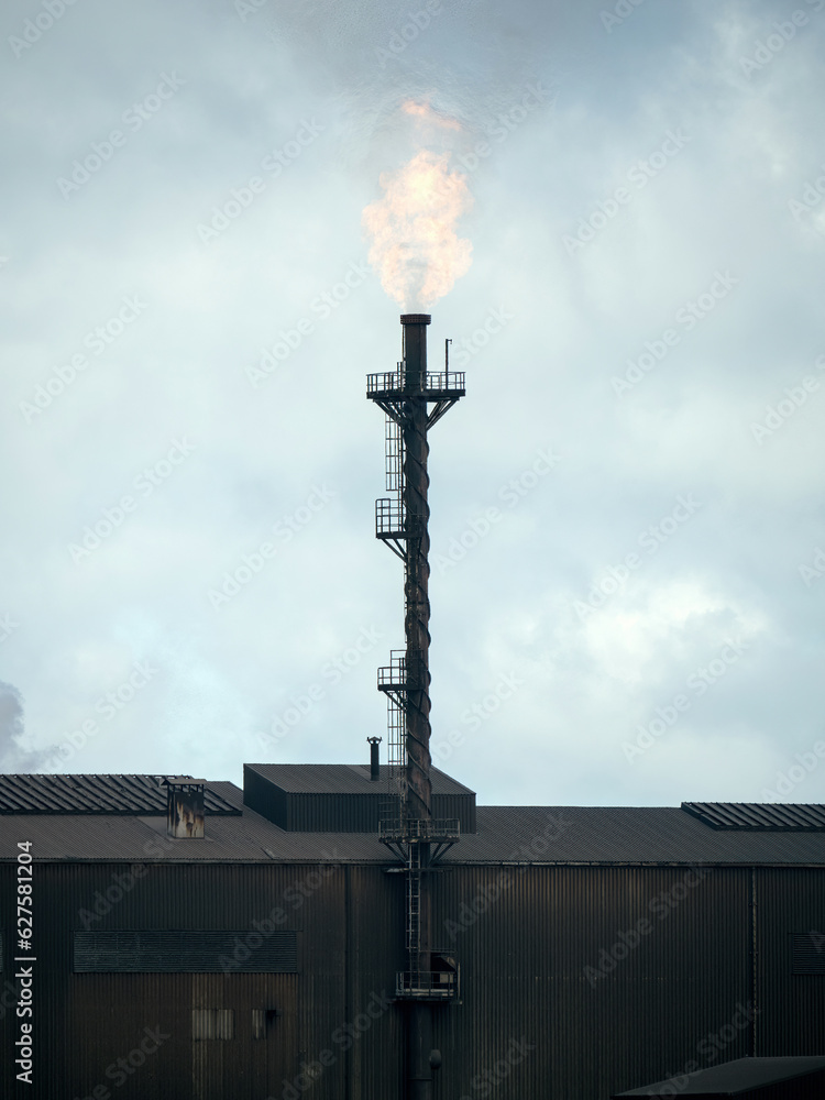 Flare stack burning exhaust gas with flame Flare stack burning exhaust gas with flame