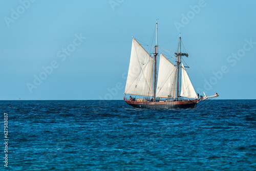old wooden sail ship , on the ocean off the coast of cornwall uk , landscap photo